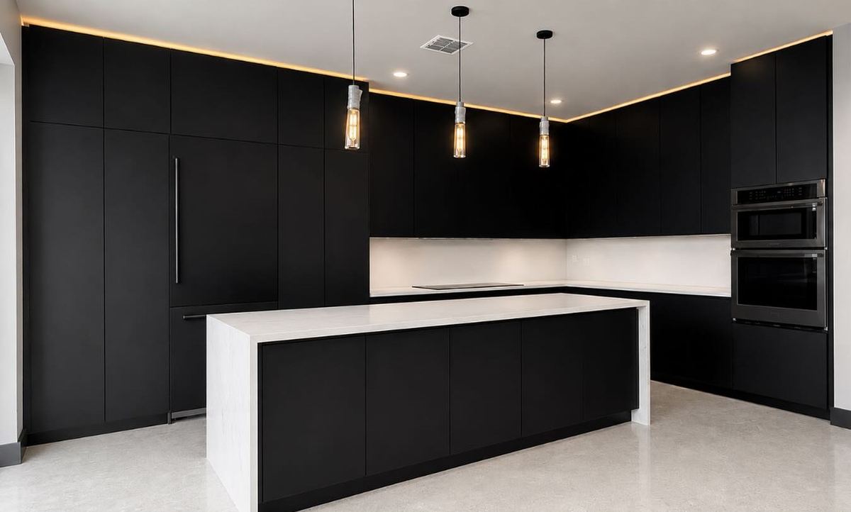 Matte black custom kitchen with a waterfall island and pendant lighting