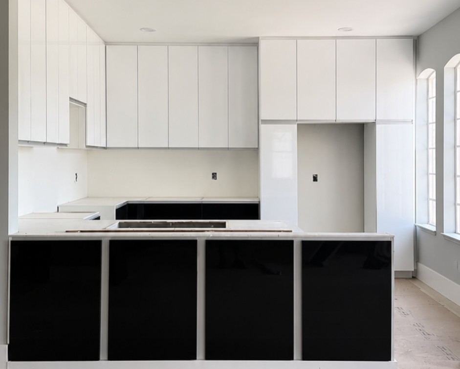 Glossy white and black custom kitchen with a long island