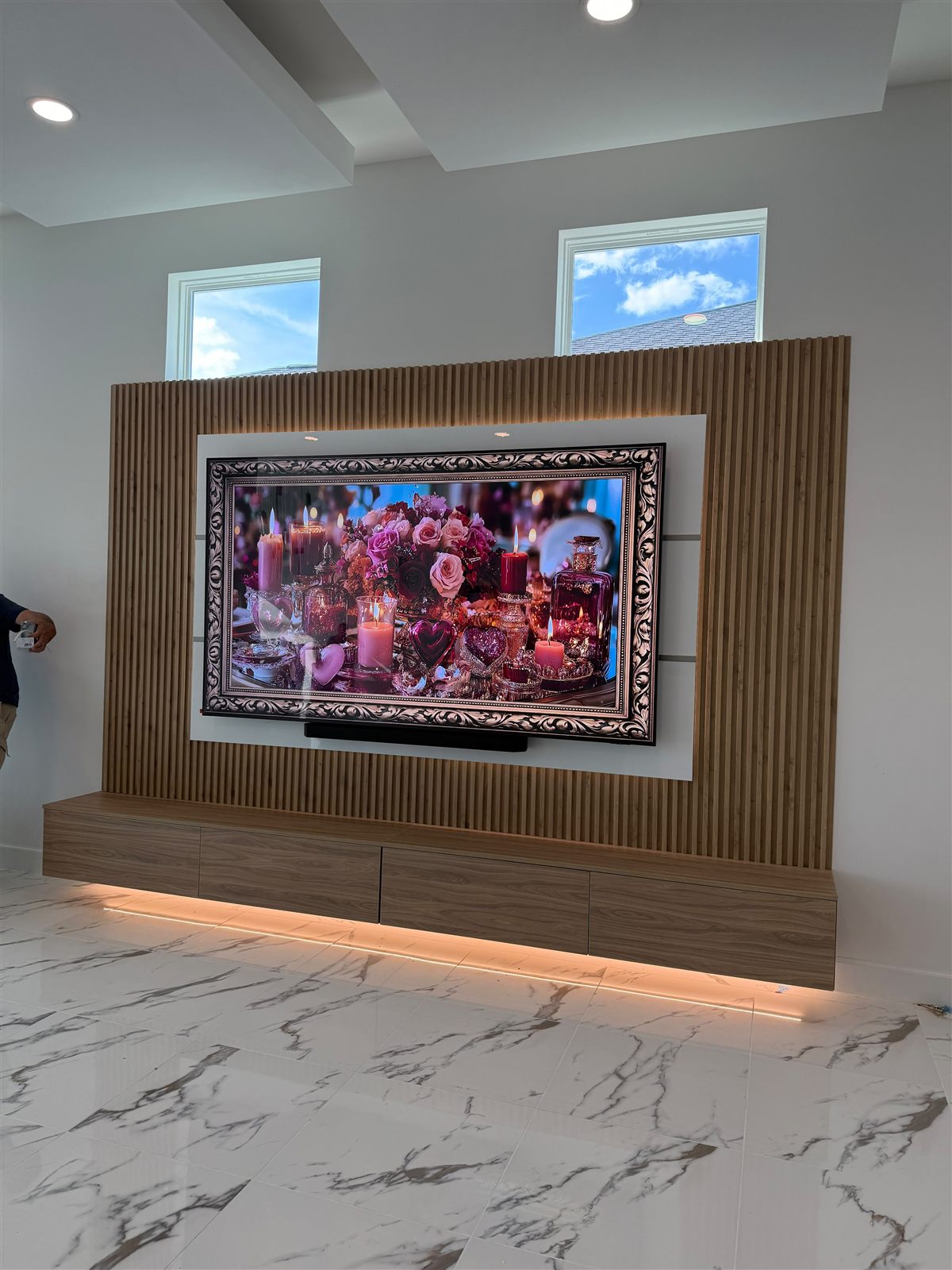 Fluted slat media wall with floating console and LED underglow
