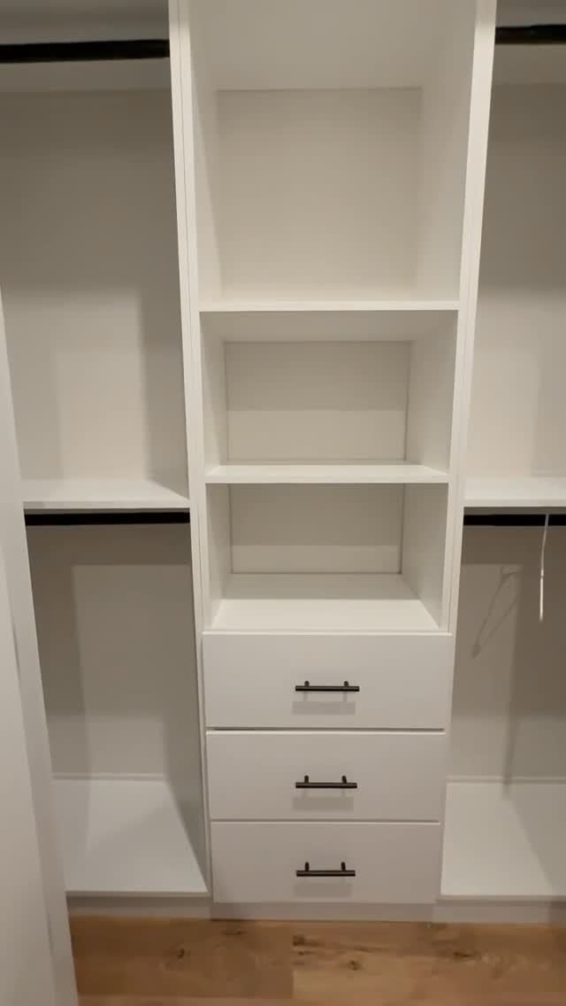 Compact white reach-in closet with drawers and adjustable shelving