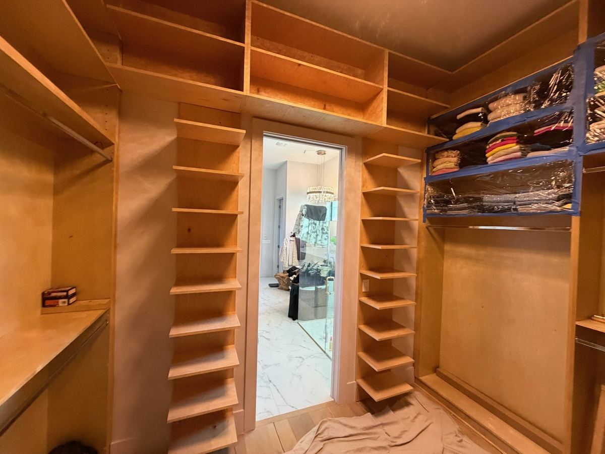 Birch walk-in closet with a full length mirror and shoe shelving