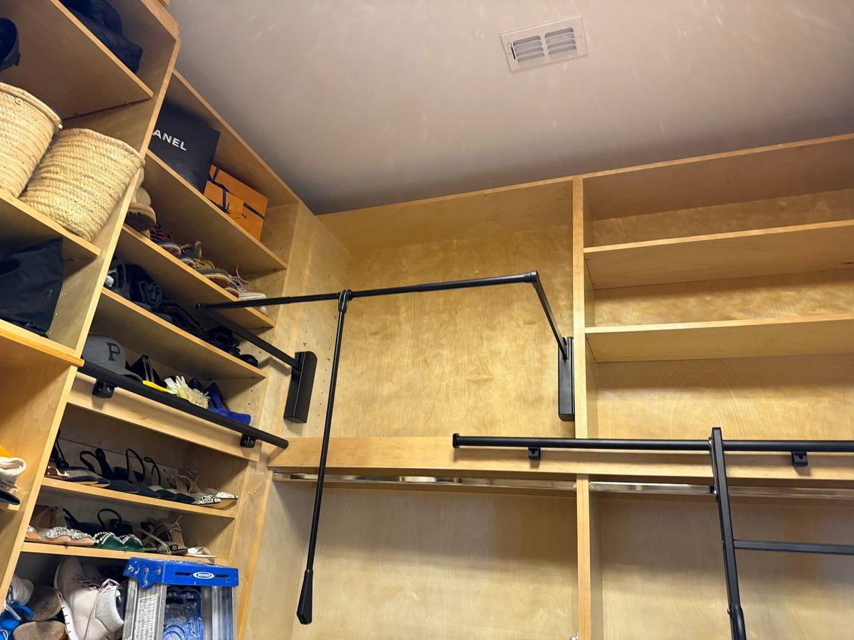 Birch walk-in closet with hanging rods and open shelving