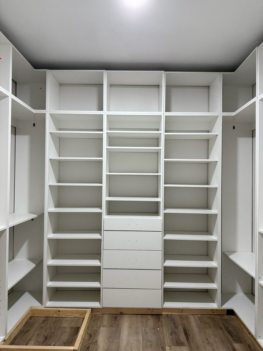 Floor to ceiling white walk-in closet shelving