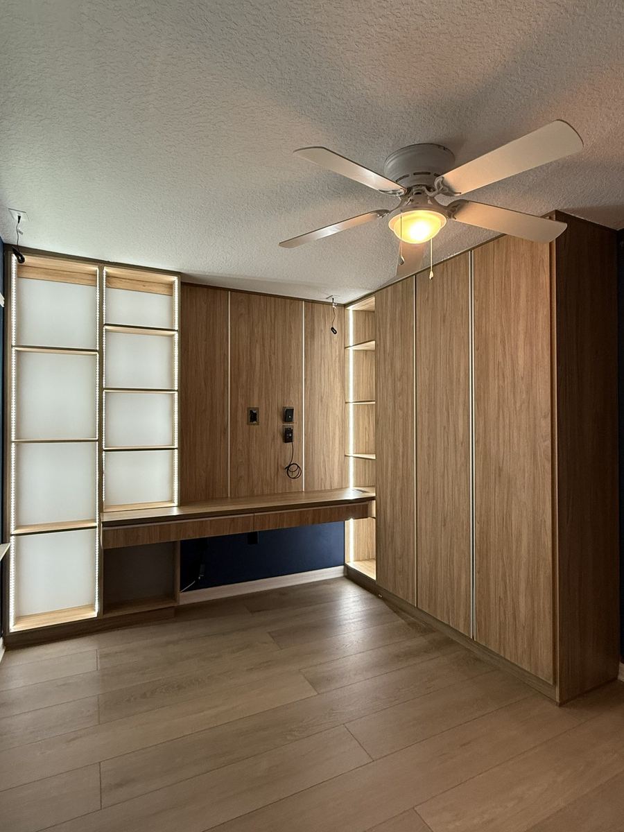 Sliding wardrobe doors beside an oak slat wall