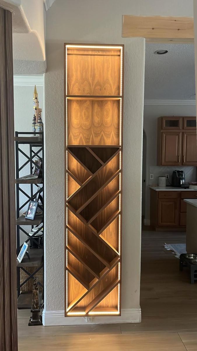 Backlit diagonal wine storage built into custom cabinetry